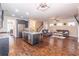 Spacious open-concept living room and kitchen area with lots of natural light and dark wood floors at 486 Raven Brook Ln, Suwanee, GA 30024