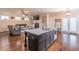 View of living room featuring built-in shelving and a fireplace adjacent to kitchen and dining area at 486 Raven Brook Ln, Suwanee, GA 30024