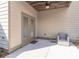 View of the patio with double doors, ceiling fan, and outdoor seating at 486 Raven Brook Ln, Suwanee, GA 30024
