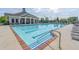 Community swimming pool with ample deck chairs and a spacious pool area with blue tiling at 486 Raven Brook Ln, Suwanee, GA 30024