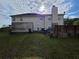Backyard with large grassy area, wooden decks, fence, and view of trees at 6948 Dalehollow Dr, Lithonia, GA 30058