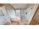 Bright bathroom featuring a shower with glass door and a soaking tub by a window at 6948 Dalehollow Dr, Lithonia, GA 30058
