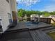 Backyard deck featuring outdoor dining, chaise lounge, and beautiful green yard at 6948 Dalehollow Dr, Lithonia, GA 30058