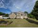 Inviting two-story brick home with manicured lawn and classic architectural details at 6948 Dalehollow Dr, Lithonia, GA 30058