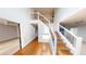 Bright foyer featuring wood-finished stairs and an open railing at 6948 Dalehollow Dr, Lithonia, GA 30058