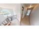 Hallway featuring wood-finished stairs and modern chandelier at 6948 Dalehollow Dr, Lithonia, GA 30058