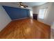 Spacious living room with hardwood floors, fireplace, and a ceiling fan at 6948 Dalehollow Dr, Lithonia, GA 30058
