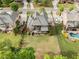 Aerial view of a beautifully landscaped backyard with a pool, patio, and lush lawn, ideal for outdoor entertaining at 1062 Meadow Grass Ln, Powder Springs, GA 30127