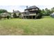 A sprawling backyard offers ample space for recreation, framed by mature trees and neighboring houses at 1062 Meadow Grass Ln, Powder Springs, GA 30127