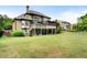 Expansive backyard featuring a deck, screened porch, and lush green lawn, perfect for outdoor entertaining and relaxation at 1062 Meadow Grass Ln, Powder Springs, GA 30127