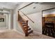 Basement staircase with wooden railings, carpeted steps, and a finished basement entrance, providing easy access at 1062 Meadow Grass Ln, Powder Springs, GA 30127