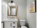 Bathroom with a modern vanity, framed mirror, and stylish fixtures at 1062 Meadow Grass Ln, Powder Springs, GA 30127