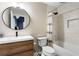Bathroom with modern fixtures, wood vanity, and a tub-shower combo at 1062 Meadow Grass Ln, Powder Springs, GA 30127