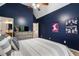 Bedroom with a high ceiling, modern posters, and a full bathroom at 1062 Meadow Grass Ln, Powder Springs, GA 30127