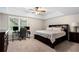 Comfortable bedroom with a ceiling fan, a work space, and plenty of natural light, ideal for relaxation and productivity at 1062 Meadow Grass Ln, Powder Springs, GA 30127