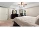 Well-lit bedroom featuring a work space, closet, and a comfortable bed, providing a functional and inviting atmosphere at 1062 Meadow Grass Ln, Powder Springs, GA 30127