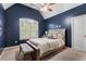 Bedroom with a high ceiling, comfortable furnishings, and natural light at 1062 Meadow Grass Ln, Powder Springs, GA 30127