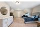 Spacious bedroom with ensuite and plenty of natural light, featuring a decorative mirror and a modern dresser at 1062 Meadow Grass Ln, Powder Springs, GA 30127
