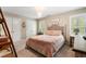 Bedroom with a modern chandelier, plush bedding, and natural light at 1062 Meadow Grass Ln, Powder Springs, GA 30127