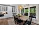 Dining area with a wooden table, black chairs, and natural light in a modern home at 1062 Meadow Grass Ln, Powder Springs, GA 30127