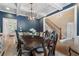Dining room with navy walls, coffered ceilings, dark wood table and chairs, open to the foyer at 1062 Meadow Grass Ln, Powder Springs, GA 30127