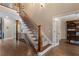 Staircase with detailed wrought iron railing with hardwood floors leads to study through an open doorway at 1062 Meadow Grass Ln, Powder Springs, GA 30127