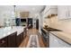 Gourmet kitchen features a large island, stainless appliances, stone backsplash, and open floor plan at 1062 Meadow Grass Ln, Powder Springs, GA 30127