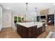 Kitchen island with bar sink and dining area featuring outdoor views and natural lighting at 1062 Meadow Grass Ln, Powder Springs, GA 30127
