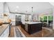 Bright kitchen features a large island, stainless steel appliances, hardwood floors, and a dining area at 1062 Meadow Grass Ln, Powder Springs, GA 30127