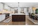 Open kitchen with island, dining area, and stainless steel appliances at 1062 Meadow Grass Ln, Powder Springs, GA 30127