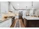 Spacious kitchen with white cabinetry, stainless steel appliances, gas range, and a kitchen island at 1062 Meadow Grass Ln, Powder Springs, GA 30127