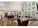 Open floor plan with living room with large windows, high ceilings, and modern kitchen at 1062 Meadow Grass Ln, Powder Springs, GA 30127
