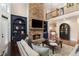 Inviting living room featuring stone fireplace, built-in shelving, and comfortable seating at 1062 Meadow Grass Ln, Powder Springs, GA 30127