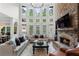 Bright living room with stone fireplace, large windows, and comfortable seating at 1062 Meadow Grass Ln, Powder Springs, GA 30127