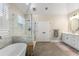 Modern main bathroom with a soaking tub, glass shower, and white vanity at 1062 Meadow Grass Ln, Powder Springs, GA 30127