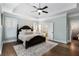 Main bedroom with trey ceilings, hardwood floors, and an ensuite bathroom at 1062 Meadow Grass Ln, Powder Springs, GA 30127