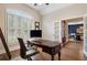 Home office with wood desk, chair, and light-filled window with plantation shutters at 1062 Meadow Grass Ln, Powder Springs, GA 30127
