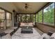 Spacious screened porch with comfortable seating, rug, and a view of the backyard at 1062 Meadow Grass Ln, Powder Springs, GA 30127