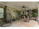 Inviting covered porch with rocking chairs, a hanging chair, and outdoor grill area at 1062 Meadow Grass Ln, Powder Springs, GA 30127