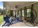 Covered porch featuring blue Adirondack chairs, a fire pit, and an outdoor ceiling fan at 1062 Meadow Grass Ln, Powder Springs, GA 30127