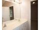 Bright bathroom featuring double sinks and a large mirror at 1120 Lake Lucerne Rd, Lilburn, GA 30047