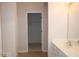 Well lit bathroom features a single sink vanity and access to closet at 1120 Lake Lucerne Rd, Lilburn, GA 30047