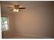 Cozy bedroom with plush carpet, ceiling fan, and a bright window at 1120 Lake Lucerne Rd, Lilburn, GA 30047