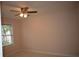 Cozy bedroom featuring a ceiling fan and a window bringing in natural light at 1120 Lake Lucerne Rd, Lilburn, GA 30047