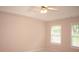 Spacious bedroom features a ceiling fan and two windows letting in natural light at 1120 Lake Lucerne Rd, Lilburn, GA 30047