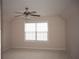 Bright bedroom features a ceiling fan and a large window with natural light at 1120 Lake Lucerne Rd, Lilburn, GA 30047