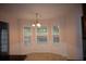 Bright dining nook with three large windows and a modern chandelier at 1120 Lake Lucerne Rd, Lilburn, GA 30047