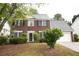 Charming two-story brick home featuring a well-manicured lawn and attached two car garage at 1120 Lake Lucerne Rd, Lilburn, GA 30047