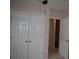 Hallway with closet doors leading to another room at 1120 Lake Lucerne Rd, Lilburn, GA 30047