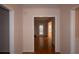 Hallway with hardwood floors and neutral walls connecting to various rooms of the home, creating seamless flow at 1120 Lake Lucerne Rd, Lilburn, GA 30047